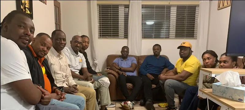 A group of young men gathered in a living room in Montreal